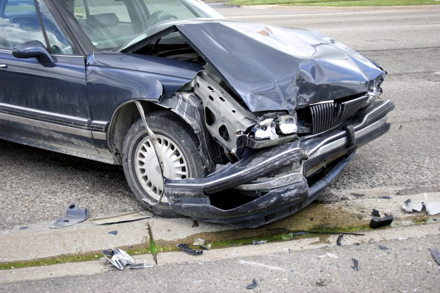 Navy Blue Sedan With Severe Front End Damage Stock Photo