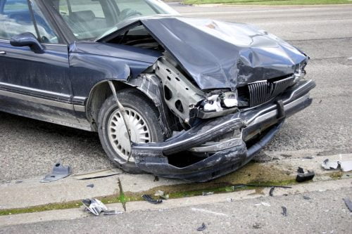 Navy Blue Sedan With Severe Front End Damage Stock Photo