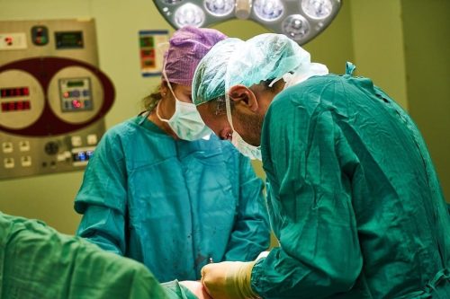 Doctors operating on a patient in a surgery room